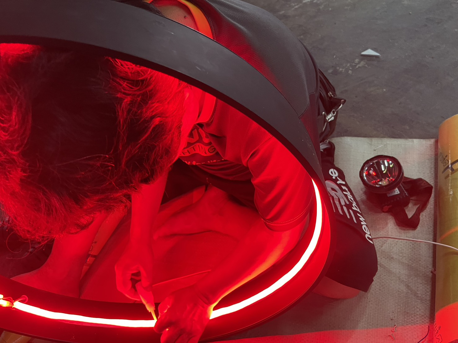 EXCESS craftsperson fabricating an illuminated sign in the workshop