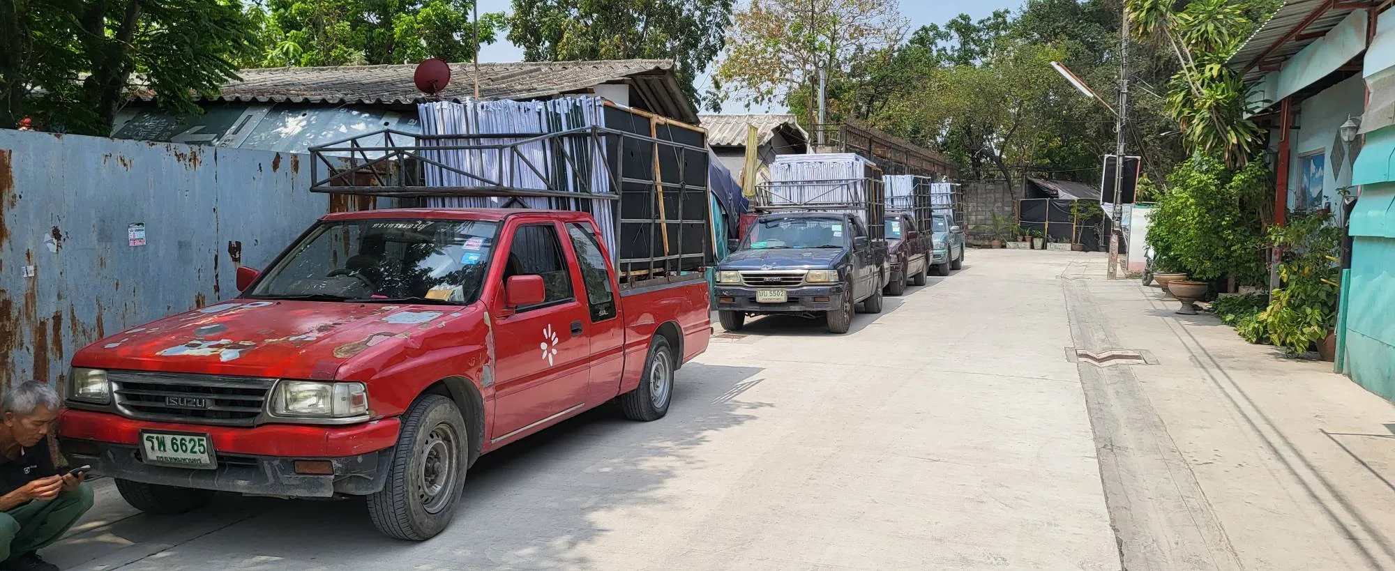 EXCESS delivery trucks loaded with fabricated sign frames at the workshop
